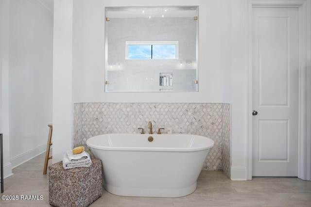 full bathroom with a freestanding bath and tile walls