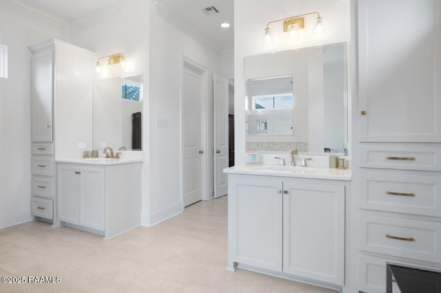 bathroom with a sink, visible vents, two vanities, and ornamental molding