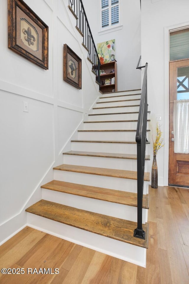 stairs featuring wood finished floors