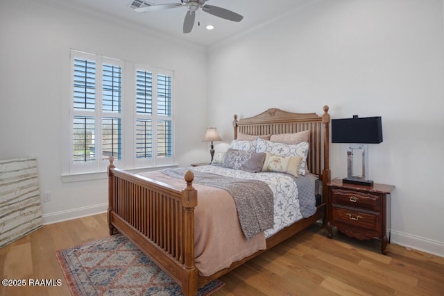 bedroom featuring wood finished floors, baseboards, recessed lighting, ceiling fan, and ornamental molding