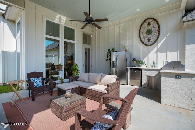 view of patio with a sink, area for grilling, ceiling fan, and outdoor lounge area