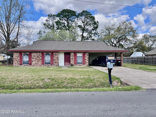 view of front of property featuring concrete driveway, a carport, brick siding, and a front lawn