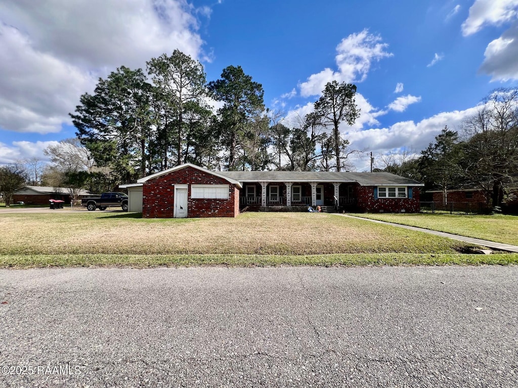 single story home with a garage, brick siding, and a front yard