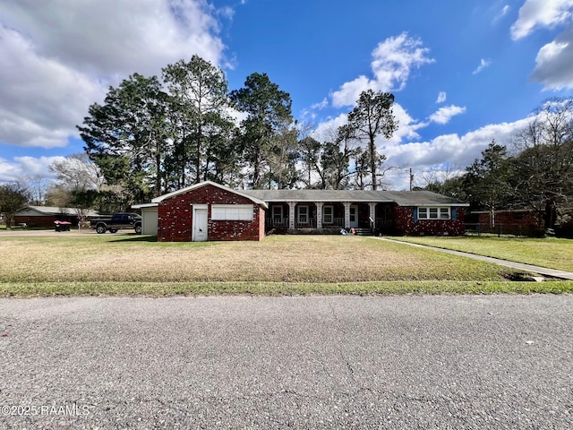 single story home with a garage, brick siding, and a front yard