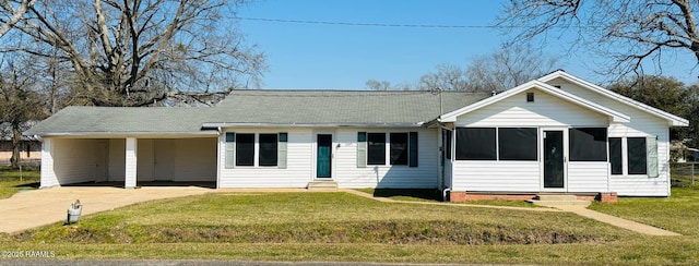 1107 Railroad St, Pine Prairie, LA 70576 - ranch-style home featuring driveway, a sunroom, entry steps, a carport, and a front lawn