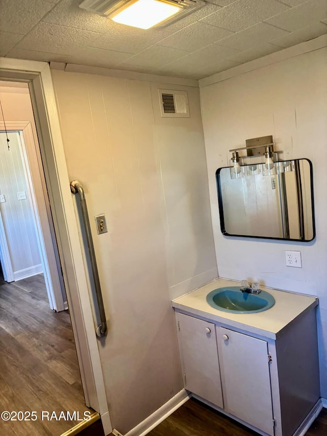 1107 Railroad St, Pine Prairie, LA 70576 - bathroom featuring visible vents, baseboards, wood finished floors, and vanity