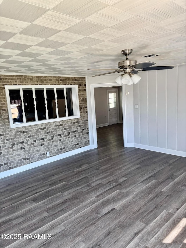 1107 Railroad St, Pine Prairie, LA 70576 - spare room with visible vents, wood finished floors, ceiling fan, and brick wall