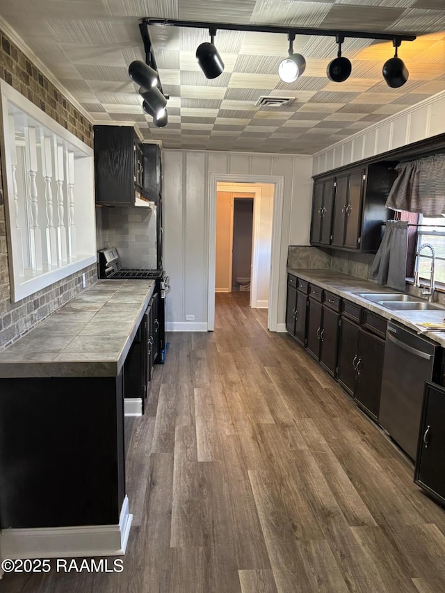 1107 Railroad St, Pine Prairie, LA 70576 - kitchen with dark wood-style floors, visible vents, stainless steel appliances, tile counters, and tasteful backsplash