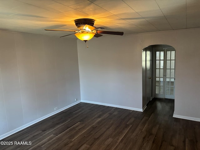 1107 Railroad St, Pine Prairie, LA 70576 - unfurnished room featuring arched walkways, baseboards, dark wood-type flooring, and ceiling fan