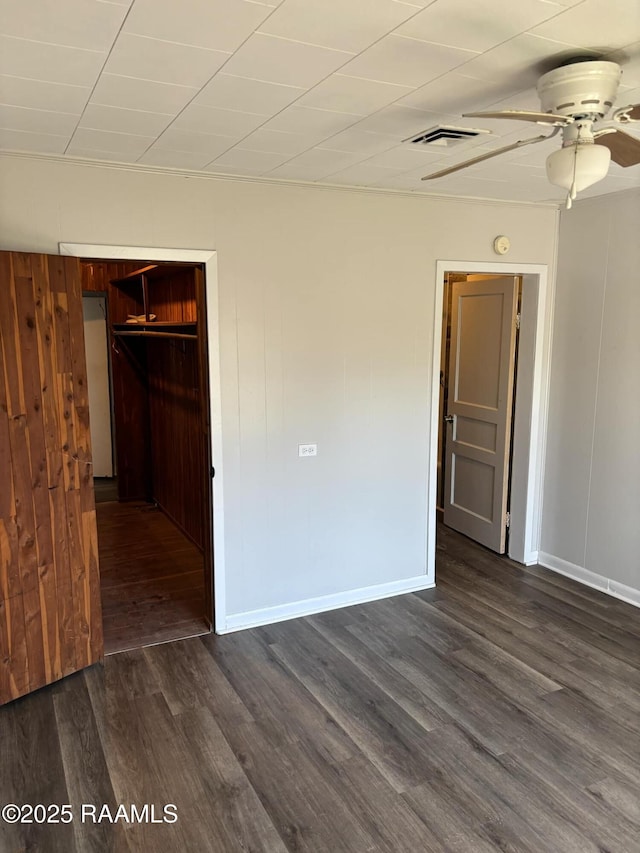 1107 Railroad St, Pine Prairie, LA 70576 - unfurnished bedroom with visible vents, dark wood-type flooring, a closet, baseboards, and ceiling fan