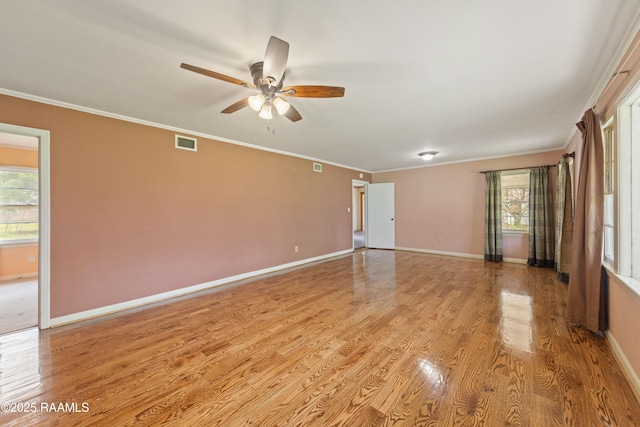 unfurnished room with baseboards, light wood-style flooring, a ceiling fan, and ornamental molding