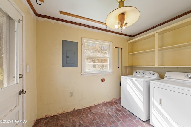 washroom with washing machine and clothes dryer, laundry area, electric panel, brick floor, and crown molding