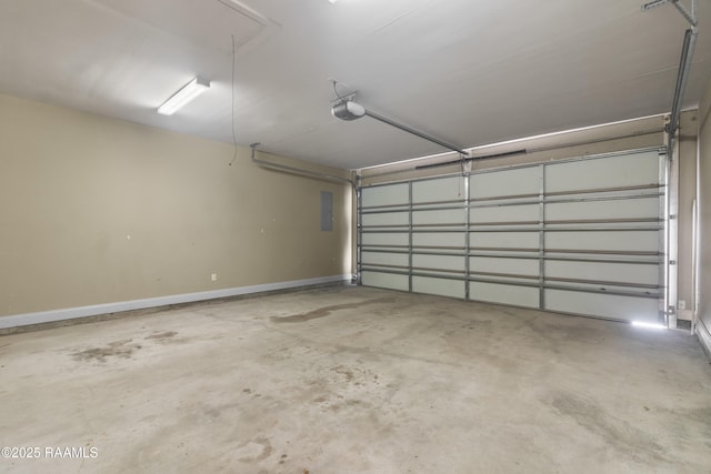 garage with electric panel, a garage door opener, and baseboards