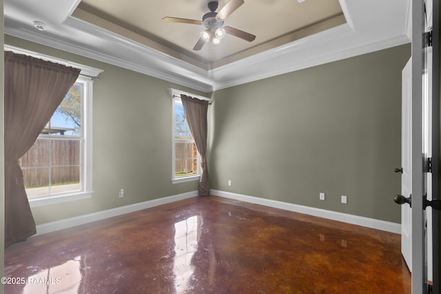 unfurnished room featuring a raised ceiling, plenty of natural light, finished concrete flooring, baseboards, and ceiling fan