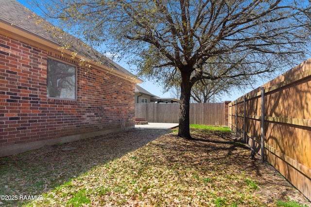 view of yard with a patio and a fenced backyard