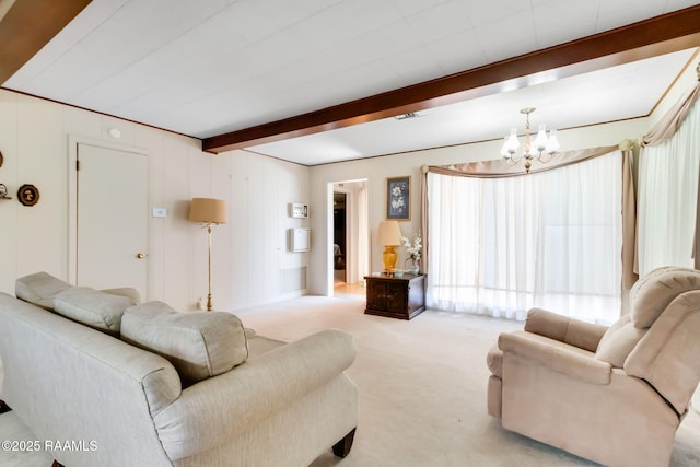 living room featuring beamed ceiling, carpet flooring, and a chandelier