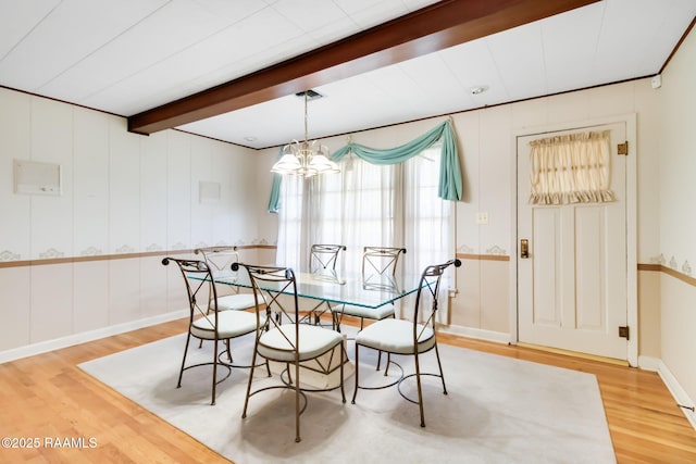 dining space featuring an inviting chandelier, beamed ceiling, light wood-style flooring, and baseboards