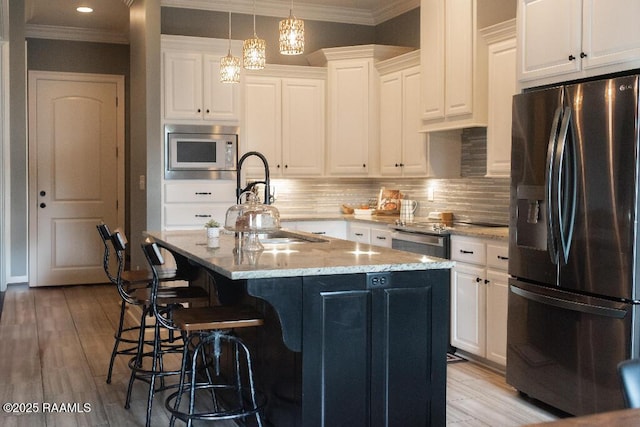 kitchen with light stone counters, stainless steel appliances, tasteful backsplash, and crown molding