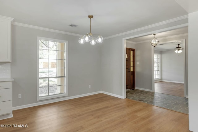 unfurnished dining area with light wood-style flooring, visible vents, and baseboards