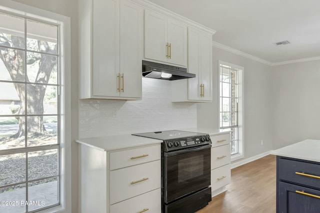 kitchen featuring visible vents, ornamental molding, light countertops, black range with electric cooktop, and under cabinet range hood