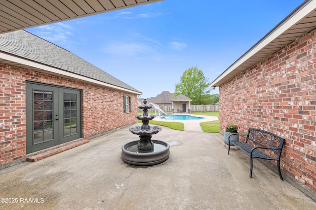view of patio / terrace with french doors, a fenced in pool, and fence