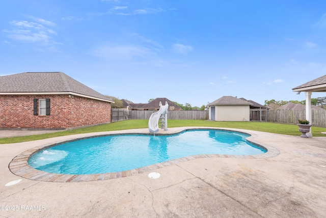 view of pool with a fenced backyard, a lawn, a water slide, and a fenced in pool