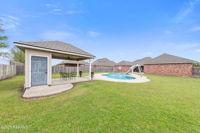 view of yard with a fenced backyard, a patio area, and a fenced in pool
