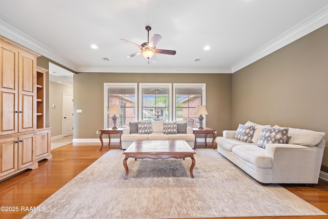 living area featuring crown molding, ceiling fan, and wood finished floors