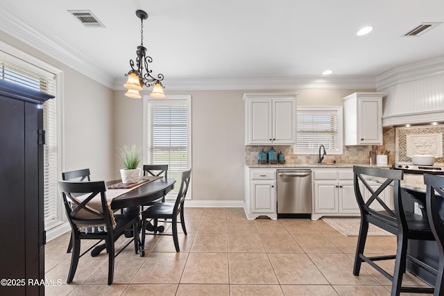 kitchen featuring stainless steel dishwasher, visible vents, ornamental molding, and light tile patterned floors