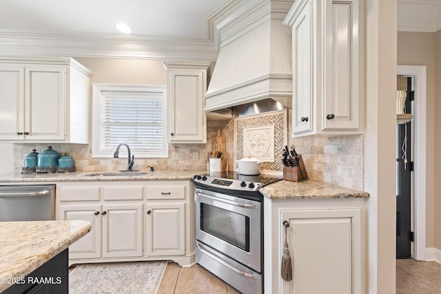 kitchen featuring custom exhaust hood, crown molding, stainless steel appliances, a sink, and light tile patterned floors