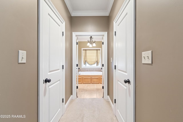 hall with light colored carpet, a notable chandelier, and crown molding