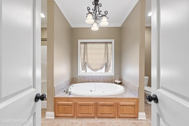 bathroom featuring tile patterned flooring, crown molding, toilet, a tub with jets, and a notable chandelier