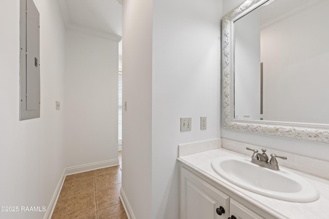 bathroom featuring tile patterned flooring, vanity, baseboards, and electric panel