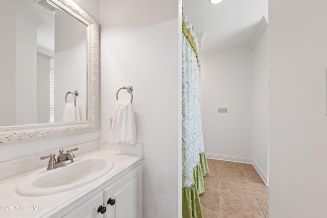 bathroom with tile patterned floors, vanity, baseboards, and visible vents