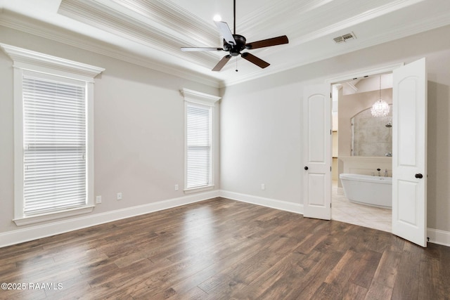 unfurnished bedroom featuring baseboards, crown molding, wood finished floors, and visible vents