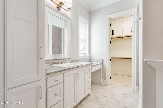 full bathroom featuring tile patterned floors, a spacious closet, vanity, baseboards, and ornamental molding