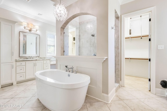 full bathroom with a freestanding tub, vanity, tiled shower, and ornamental molding