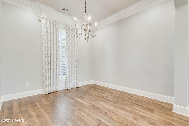 unfurnished dining area featuring light wood-style flooring, baseboards, an inviting chandelier, and ornamental molding
