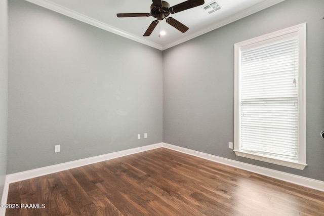 unfurnished room with ornamental molding, baseboards, dark wood-style flooring, and visible vents