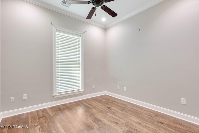 unfurnished room with wood finished floors, visible vents, crown molding, baseboards, and ceiling fan