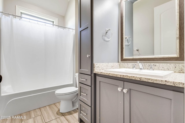 full bathroom featuring toilet, vanity, wood finished floors, and shower / bathtub combination with curtain