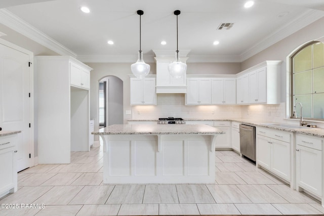 kitchen with stainless steel dishwasher, arched walkways, a sink, visible vents, and backsplash