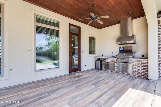 view of patio featuring exterior kitchen, grilling area, a ceiling fan, and a sink