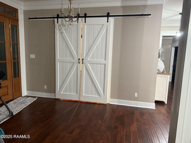 3713 Vidrine Rd, Ville Platte, LA 70586 - unfurnished dining area with a barn door, dark wood-style floors, baseboards, and ornamental molding