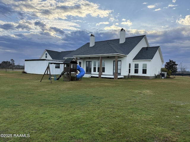 3713 Vidrine Rd, Ville Platte, LA 70586 - rear view of house with a playground, a yard, and ceiling fan