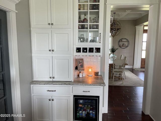 3713 Vidrine Rd, Ville Platte, LA 70586 - indoor dry bar with decorative backsplash, dark wood-style flooring, beverage cooler, and baseboards
