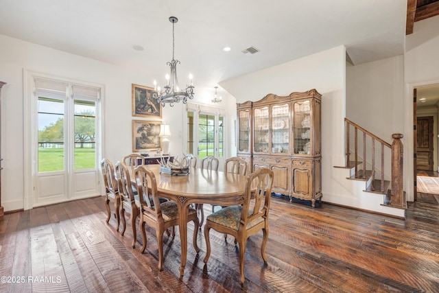 dining area with an inviting chandelier, plenty of natural light, visible vents, and dark wood-type flooring