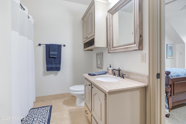 bathroom with vanity, toilet, and tile patterned flooring