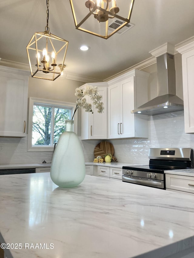 kitchen featuring a chandelier, wall chimney exhaust hood, electric range, and crown molding