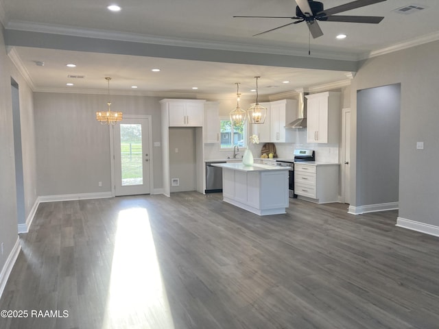 kitchen featuring a sink, visible vents, ceiling fan with notable chandelier, wall chimney range hood, and appliances with stainless steel finishes
